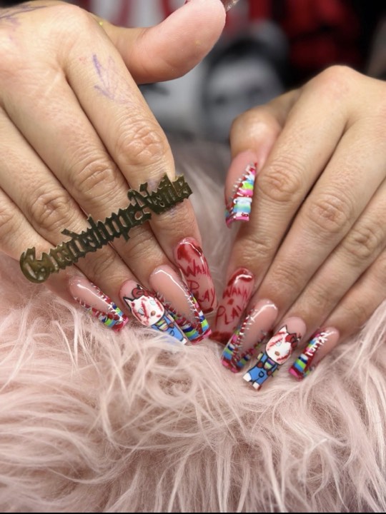 Long coffin nails with horror-movie character art and red accents