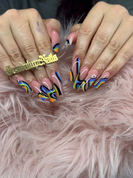 Almond nails with blue, yellow and black swirl art
