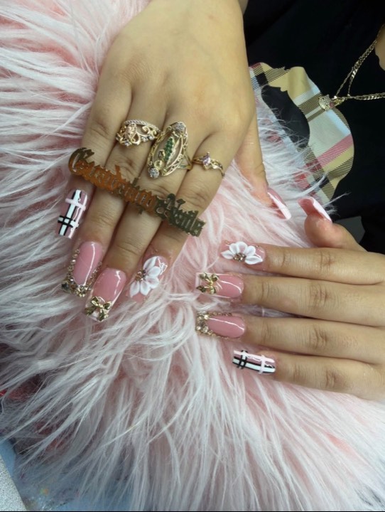 Pink square nails with 3D white flowers, gold charms and plaid accents