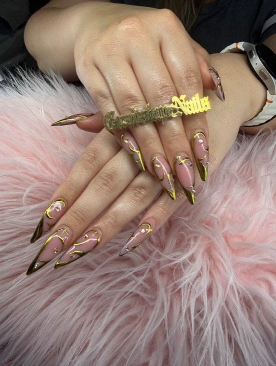 Gold chrome stiletto nails with clear tips and gold line detail