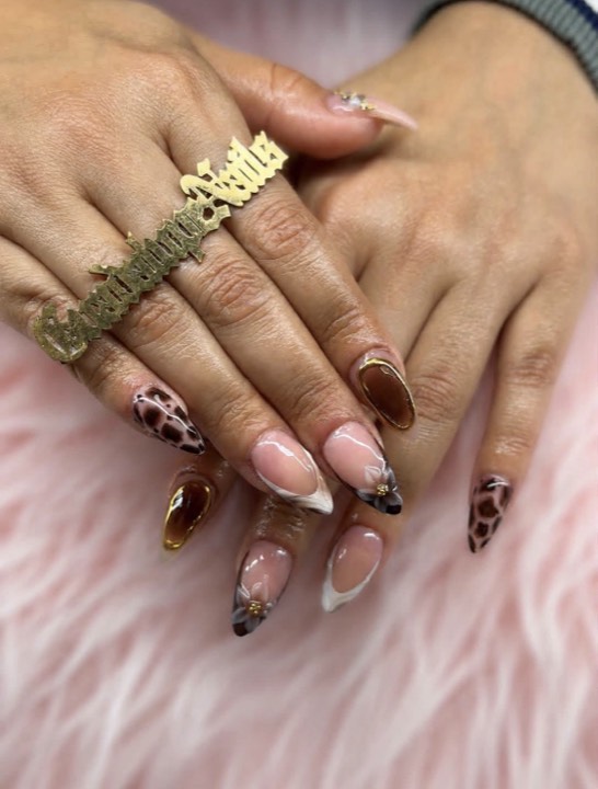 Almond nails with milky French tips, amber tortoiseshell and leopard accents