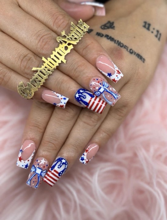 Square nails with stars-and-stripes Fourth of July art and bows
