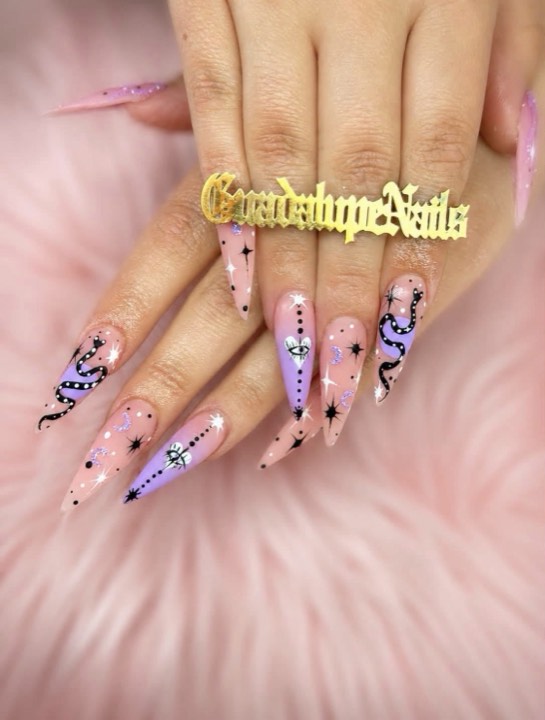 Lilac and pink stiletto nails with black serpent and star designs
