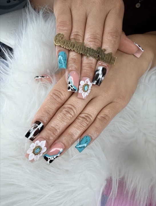 Square nails mixing turquoise, cow print and a white flower with a turquoise stone