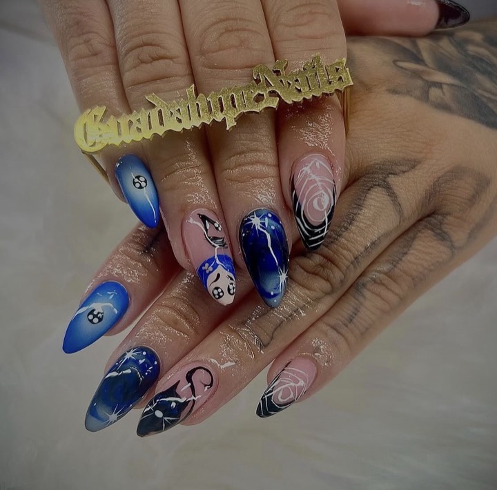 Almond nails in cobalt blue with eight-ball, cat and black-and-white swirl designs